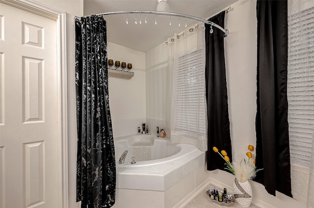 bathroom with tile patterned floors and shower / bath combo with shower curtain