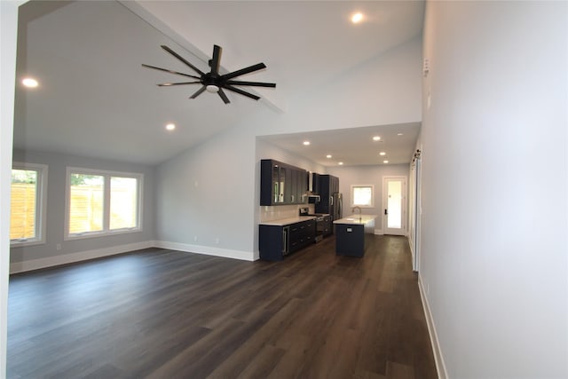 unfurnished living room featuring dark hardwood / wood-style floors, ceiling fan, and lofted ceiling