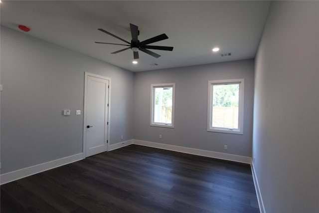 empty room with ceiling fan and dark hardwood / wood-style floors