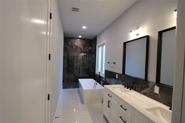 bathroom with tile patterned floors, vanity, tile walls, and shower with separate bathtub