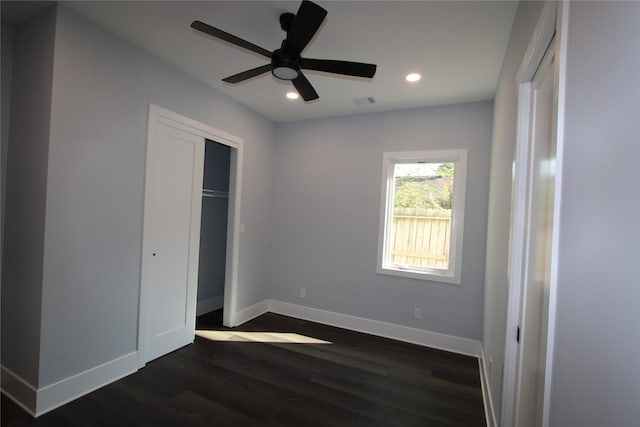 unfurnished bedroom featuring ceiling fan, dark wood-type flooring, and a closet