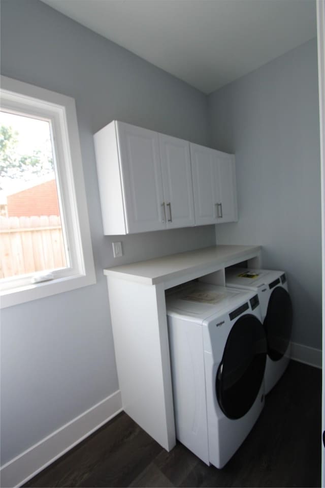 laundry room with dark hardwood / wood-style flooring, cabinets, and independent washer and dryer