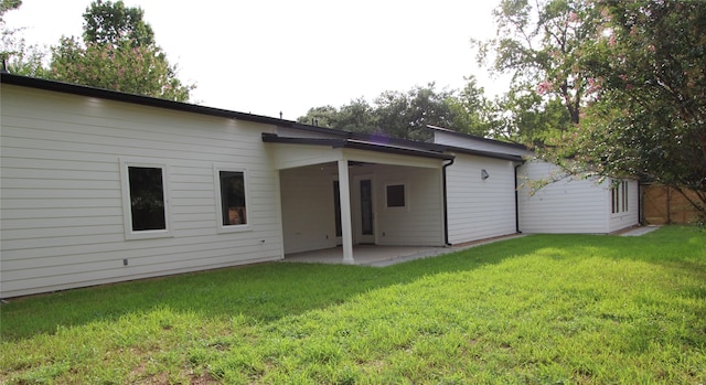 back of house featuring a yard and a patio