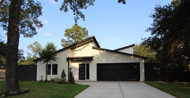 view of front of house with a garage and a front yard