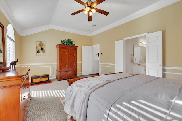 carpeted bedroom with ceiling fan, ornamental molding, ensuite bathroom, and vaulted ceiling