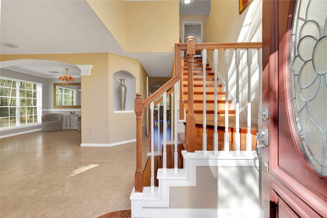 tiled foyer with crown molding