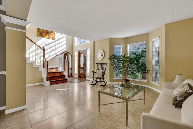 tiled living room featuring a textured ceiling