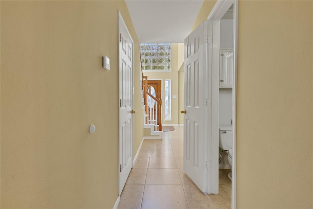 hall featuring light tile patterned floors