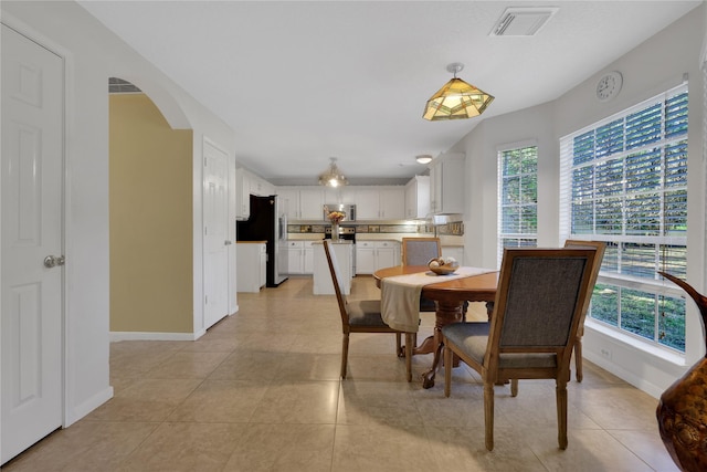 tiled dining area with a wealth of natural light