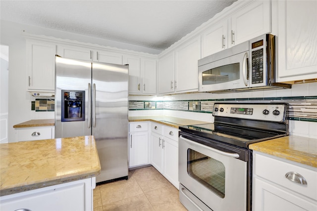 kitchen featuring a textured ceiling, white cabinetry, and stainless steel appliances