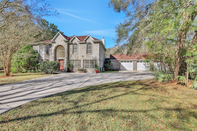 front facade featuring a garage and a front yard