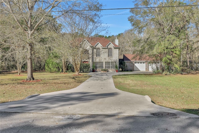 view of front of home with a garage and a front lawn