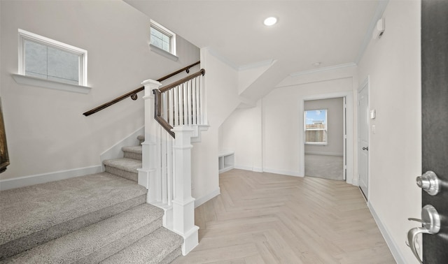 stairs with parquet floors and ornamental molding