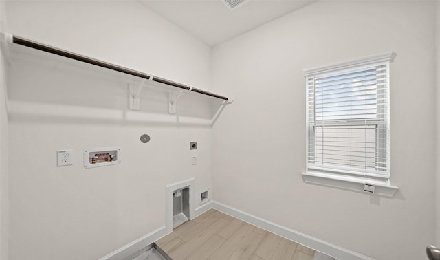 washroom with electric dryer hookup, hookup for a gas dryer, light wood-type flooring, and hookup for a washing machine