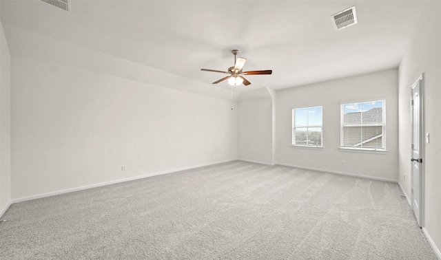 carpeted spare room featuring ceiling fan