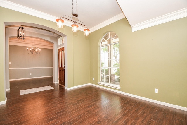 spare room with dark hardwood / wood-style flooring, an inviting chandelier, and crown molding