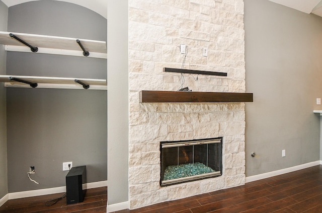 interior details with wood-type flooring and a fireplace