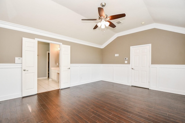 unfurnished room featuring hardwood / wood-style floors, lofted ceiling, and ornamental molding