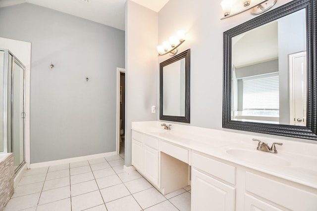 bathroom featuring tile patterned floors, vanity, toilet, and an enclosed shower