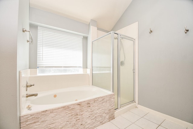 bathroom featuring tile patterned flooring, independent shower and bath, and vaulted ceiling