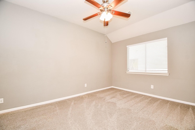 spare room featuring ceiling fan, lofted ceiling, and carpet floors