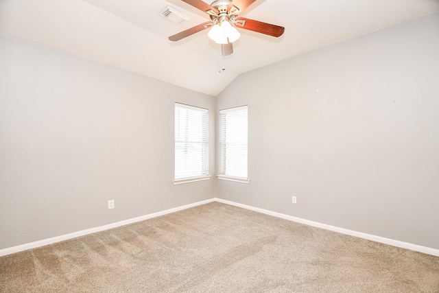 carpeted empty room with ceiling fan and vaulted ceiling