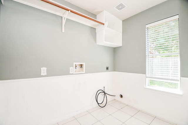 laundry room featuring hookup for an electric dryer, light tile patterned flooring, and hookup for a washing machine