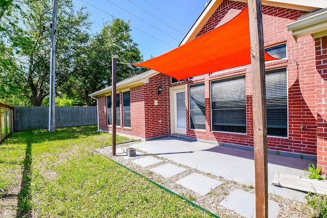 rear view of property with a lawn and a patio area