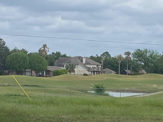 view of home's community with a yard and a water view