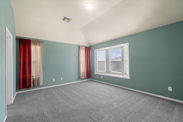 unfurnished room with carpet and lofted ceiling