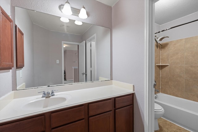 full bathroom featuring vanity, toilet, and tiled shower / bath