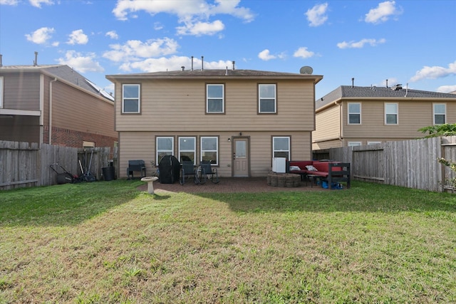 back of house with a yard and a patio