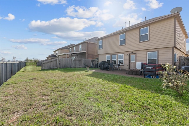 back of property with a patio area and a yard