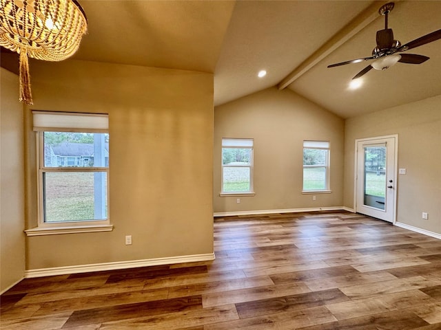 unfurnished room featuring ceiling fan with notable chandelier, wood-type flooring, and lofted ceiling with beams