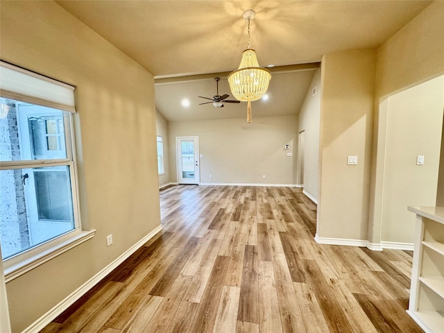 interior space with hardwood / wood-style flooring and ceiling fan with notable chandelier