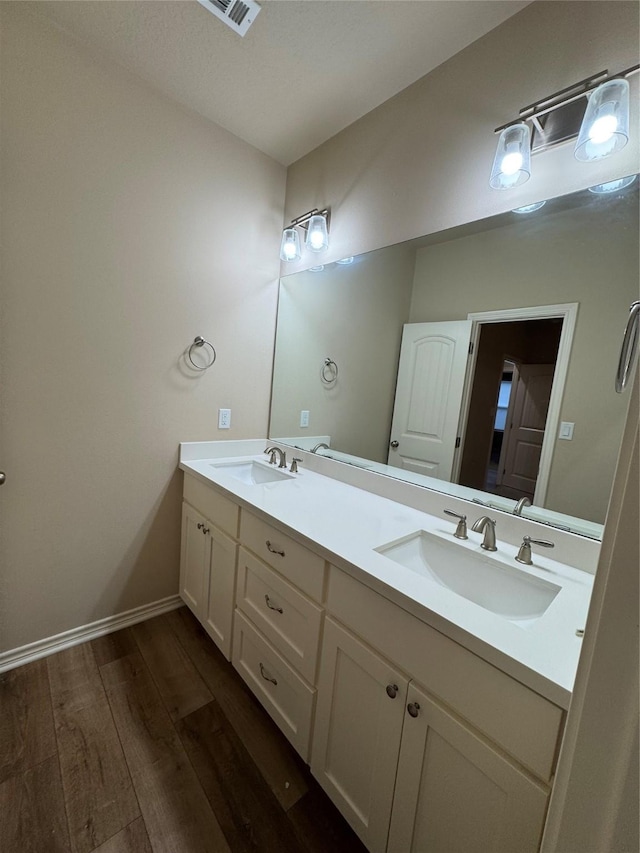 bathroom with hardwood / wood-style flooring and vanity