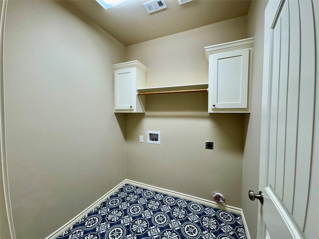 laundry area with washer hookup, electric dryer hookup, and a textured ceiling