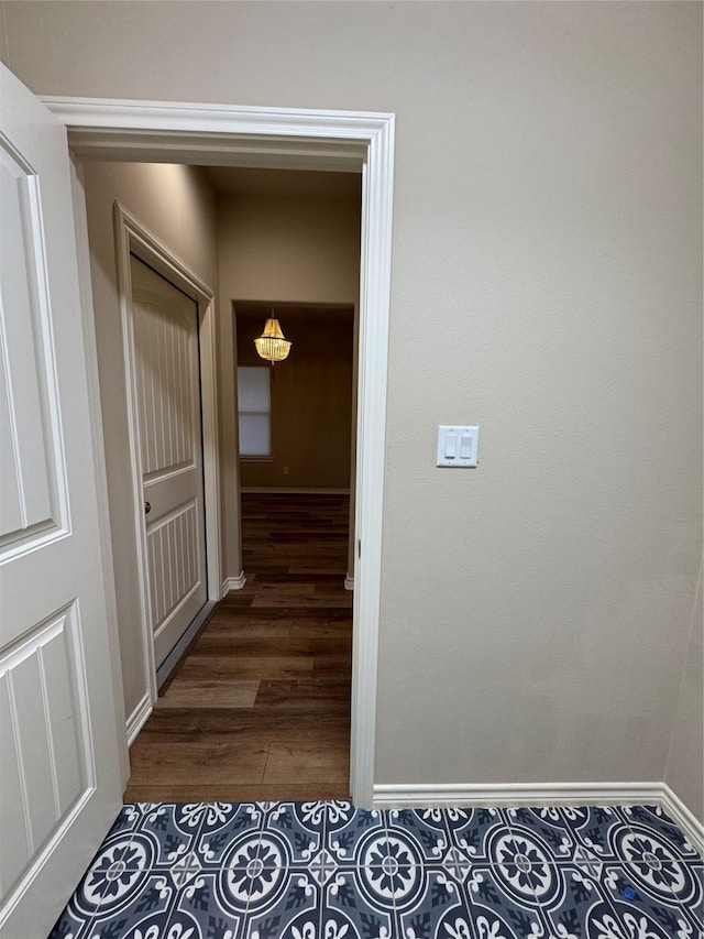 corridor with dark hardwood / wood-style flooring