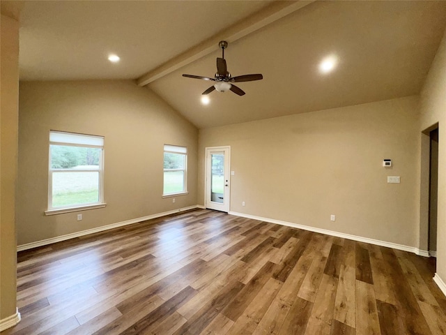 unfurnished room featuring ceiling fan, lofted ceiling with beams, dark wood-type flooring, and plenty of natural light