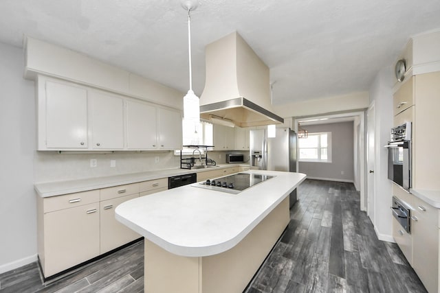 kitchen featuring a center island, sink, island exhaust hood, decorative light fixtures, and black appliances