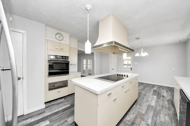 kitchen with black appliances, decorative light fixtures, a center island, and island exhaust hood