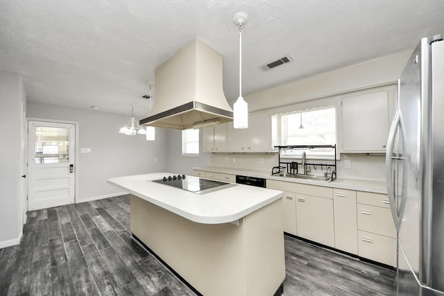 kitchen featuring hanging light fixtures, a center island, black appliances, and ventilation hood