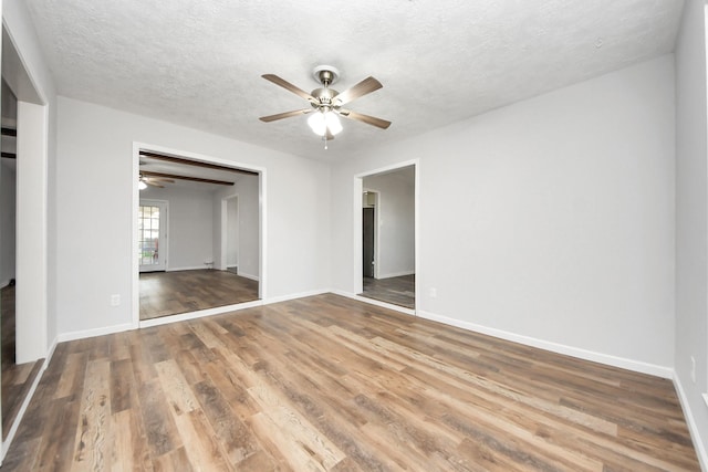 interior space with ceiling fan, a textured ceiling, and hardwood / wood-style flooring