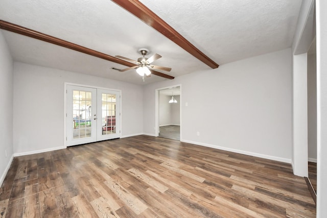 spare room with french doors, dark hardwood / wood-style flooring, a textured ceiling, and ceiling fan