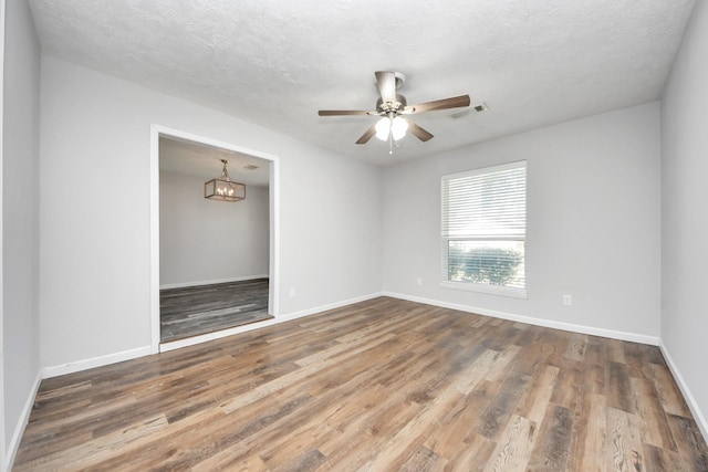 spare room featuring a textured ceiling, ceiling fan, and dark hardwood / wood-style floors