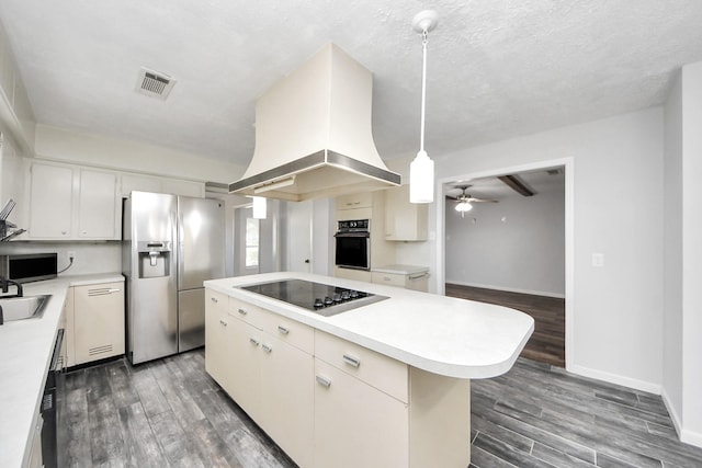 kitchen featuring black appliances, decorative light fixtures, a kitchen island, white cabinetry, and island exhaust hood