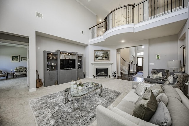 carpeted living room with a high ceiling