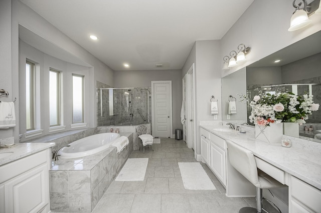 bathroom with tile patterned flooring, vanity, and plus walk in shower