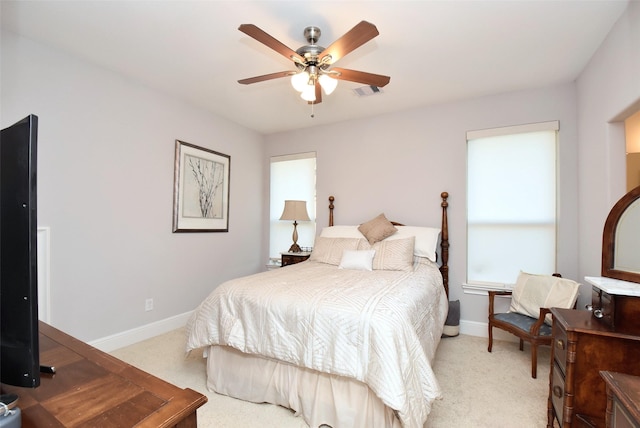 bedroom featuring ceiling fan and light carpet