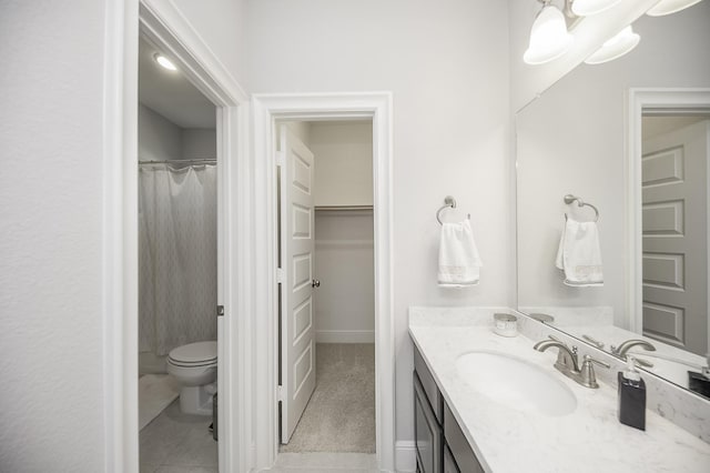 bathroom featuring tile patterned flooring, vanity, and toilet